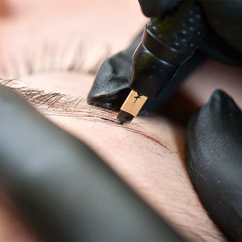 Close up of eyebrow tatto being performed in cosmetic clinic